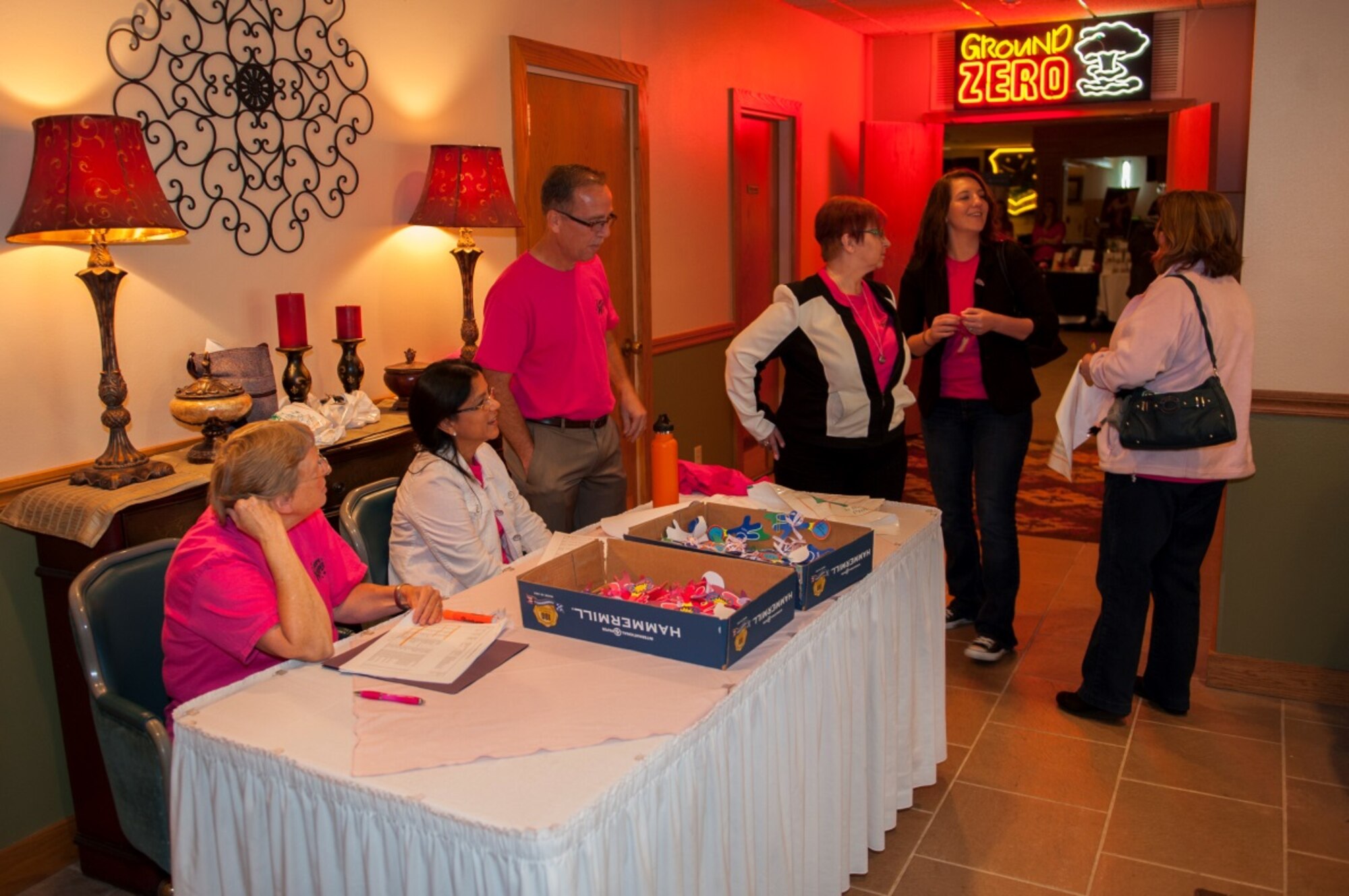 Members of Minot Air Force Base greet people at the door during the annual breast cancer awareness luncheon at Minot AFB, N.D., Oct. 9, 2015. The luncheon featured silent auctions and raffles in support of breast cancer research funding. (U.S. Air Force photo/Airman 1st Class Christian Sullivan)