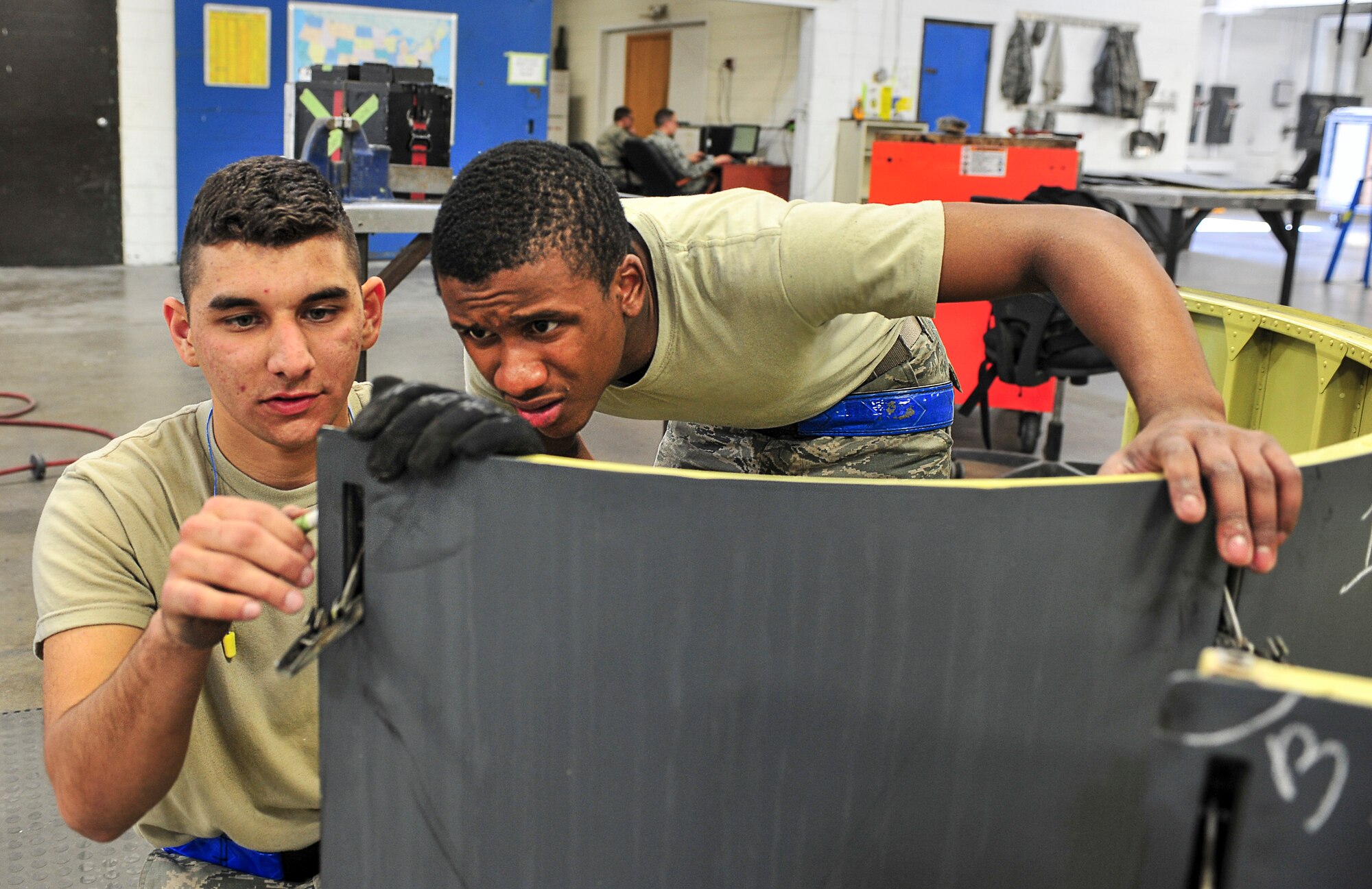 Airmen 1st Class Dustin Pace (left), 5th Maintenance Squadron aircraft structural maintenance apprentice and Airman 1st Class Gerarl Johnson (right), 5th MXS aircraft structural maintenance journeyman, label areas to repair on B-52H Stratofortress parts at Minot Air Force Base, N.D., Oct. 14, 2015. Airmen like Pace and Johnson provide on and off equipment maintenance on B-52H Stratofortresses. (U.S. Air Force photo/Senior Airman Stephanie Morris)