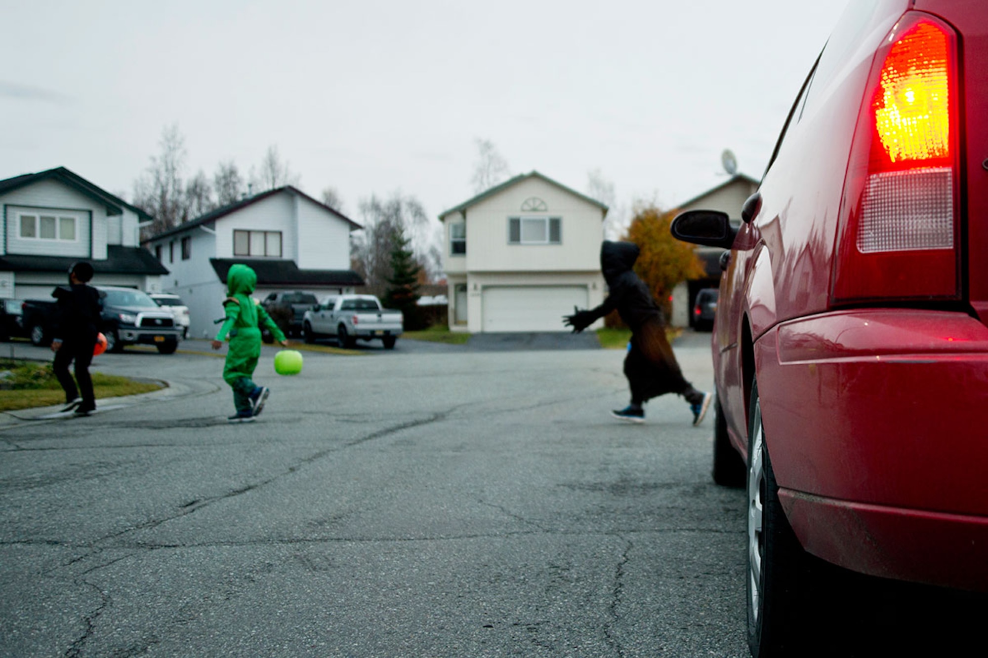 A driver stops for children crossing a street while trick-or-treating in Anchorage, Alaska. Safely using proper crosswalks while walking between streets, using flashlights and wearing proper reflective equipment can make the nighttime hunt for candy safer, said Air Force Staff Sgt. Carl Pella, 673d Security Forces Squadron noncommissioned officer in charge of corrections. Pella added drivers should be extremely cautious of children in housing areas on and off Joint Base Elmendorf-Richardson, and to keep their speed limited to 15 miles per hour during Halloween. (U.S. Air Force photo/Senior Airman Tammie Ramsouer)