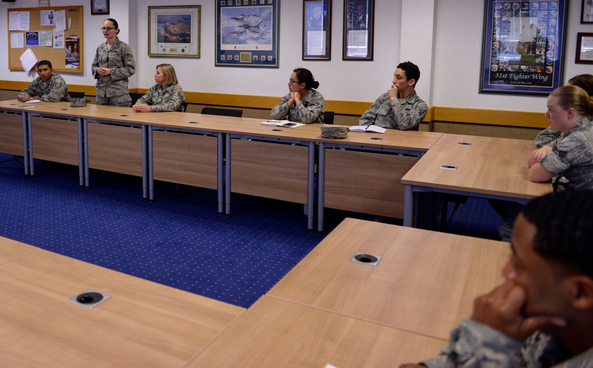 Senior Airman Amanda Jolly, standing, 786th Force Support Squadron unit deployment manager, speaks to the class during a professional development seminar Oct. 8, 2015, at Kapaun Air Station, Germany. The Kisling NCO Academy hosted the event in which Airmen reviewed books from the chief of staff of the Air Force’s 2015 reading list and how the material relates to being an Airman today's Air Force. (U.S. Air Force photo/Staff Sgt. Sharida Jackson)