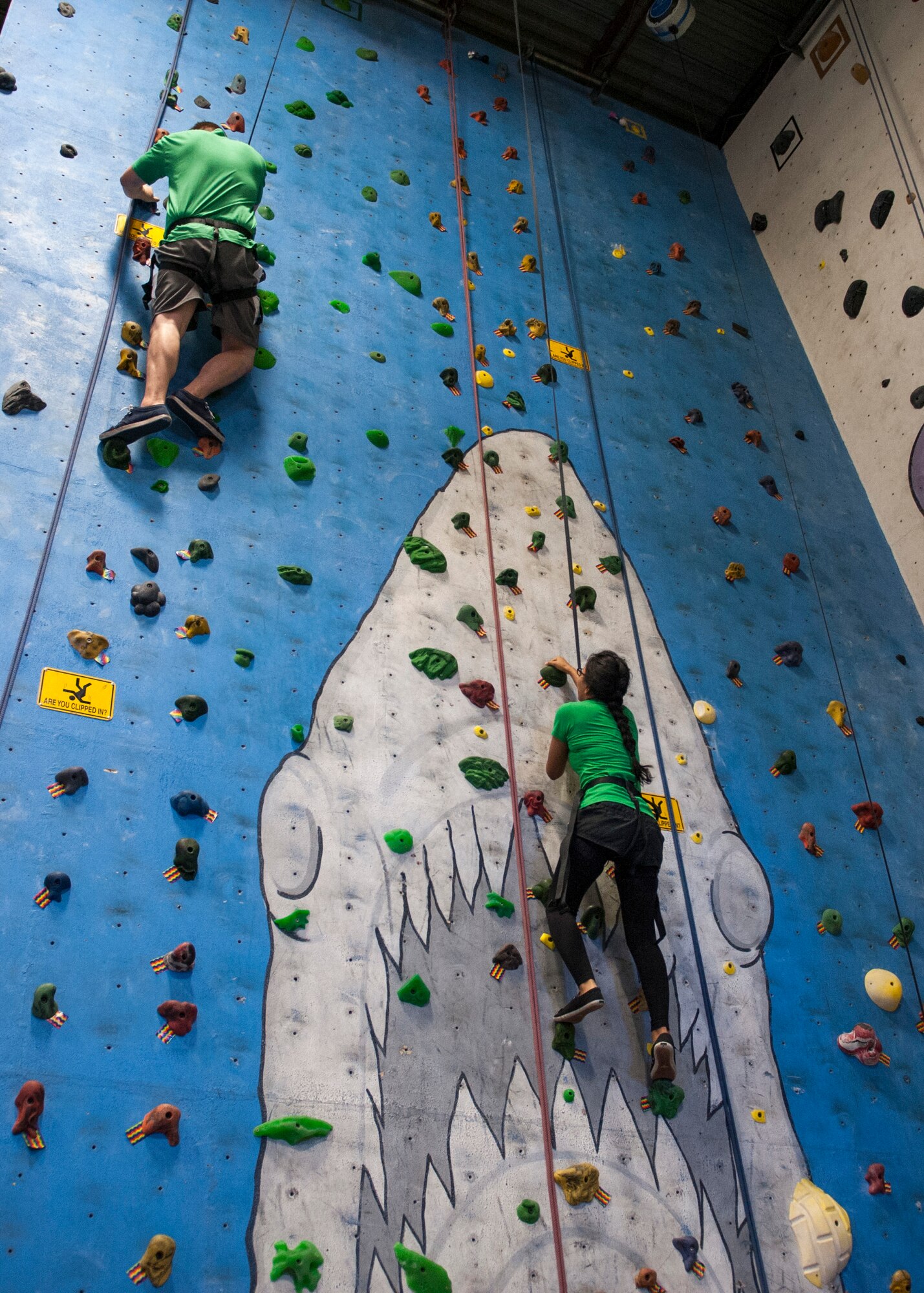 COLORADO SPRINGS, Colo. – Airman 1st Class Jessica Griffin, 21st Aerospace Medicine Squadron public health technician, right, and her husband carefully climb to the top of a wall Oct. 10, 2015 at CityROCK Climbing Center. The Peterson Chapel took a group of Airmen to the climbing center to thank them for their hard work and to build morale. (U.S. photo by Senior Airman Tiffany DeNault)