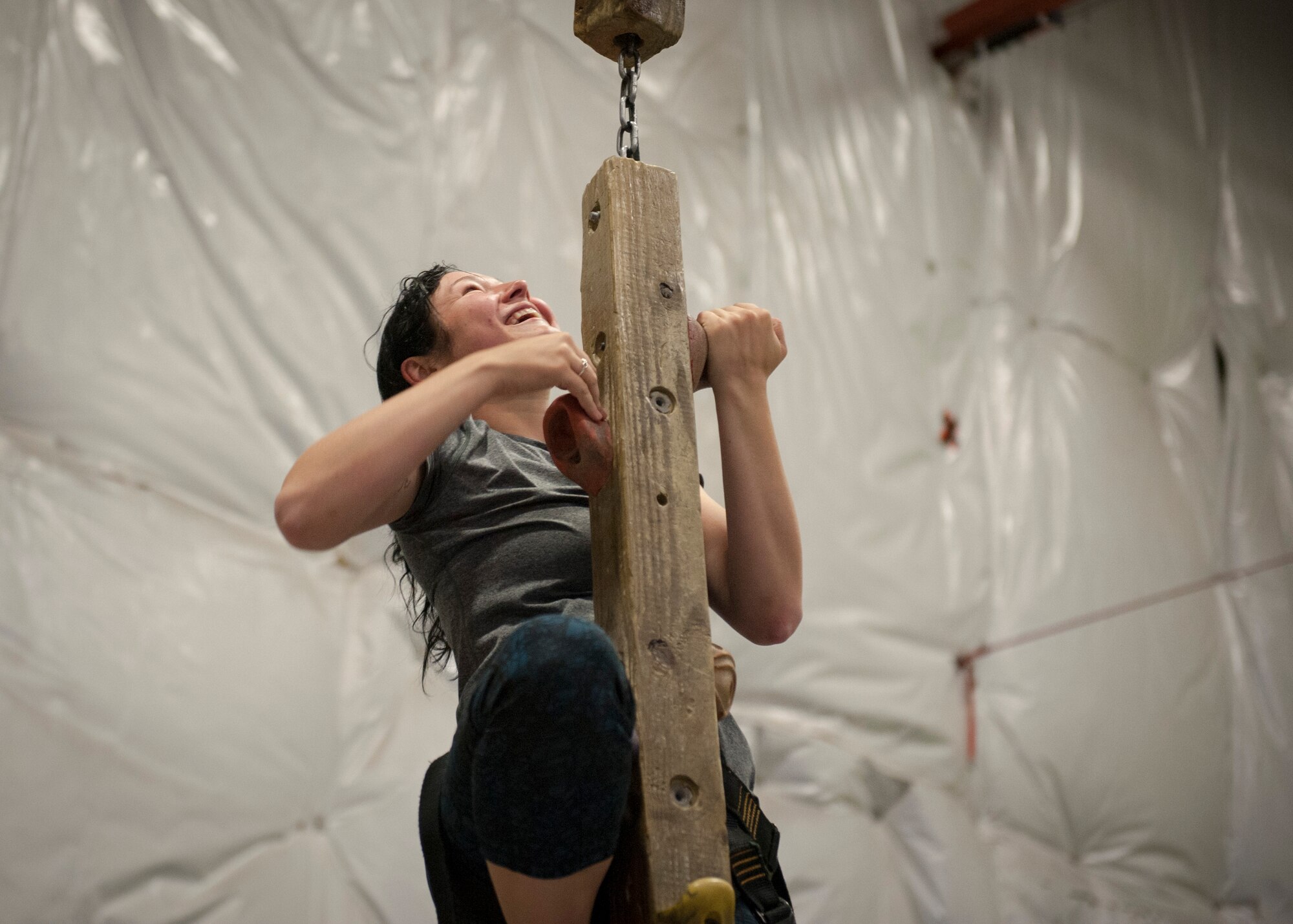 Colorado Springs, Colo. – Airman Nichole Jeter, 21st Civil Engineer Squadron electrician, climbs the “caterpillar,” a wooden climbing beam that moves back and forth instead of staying stationary like a wall, Oct. 10, 2015 at CityROCK Climbing Center. The Peterson Chapel took a group of Airmen to the climbing center to thank them for their hard work and to build morale. (U.S. photo by Senior Airman Tiffany DeNault)