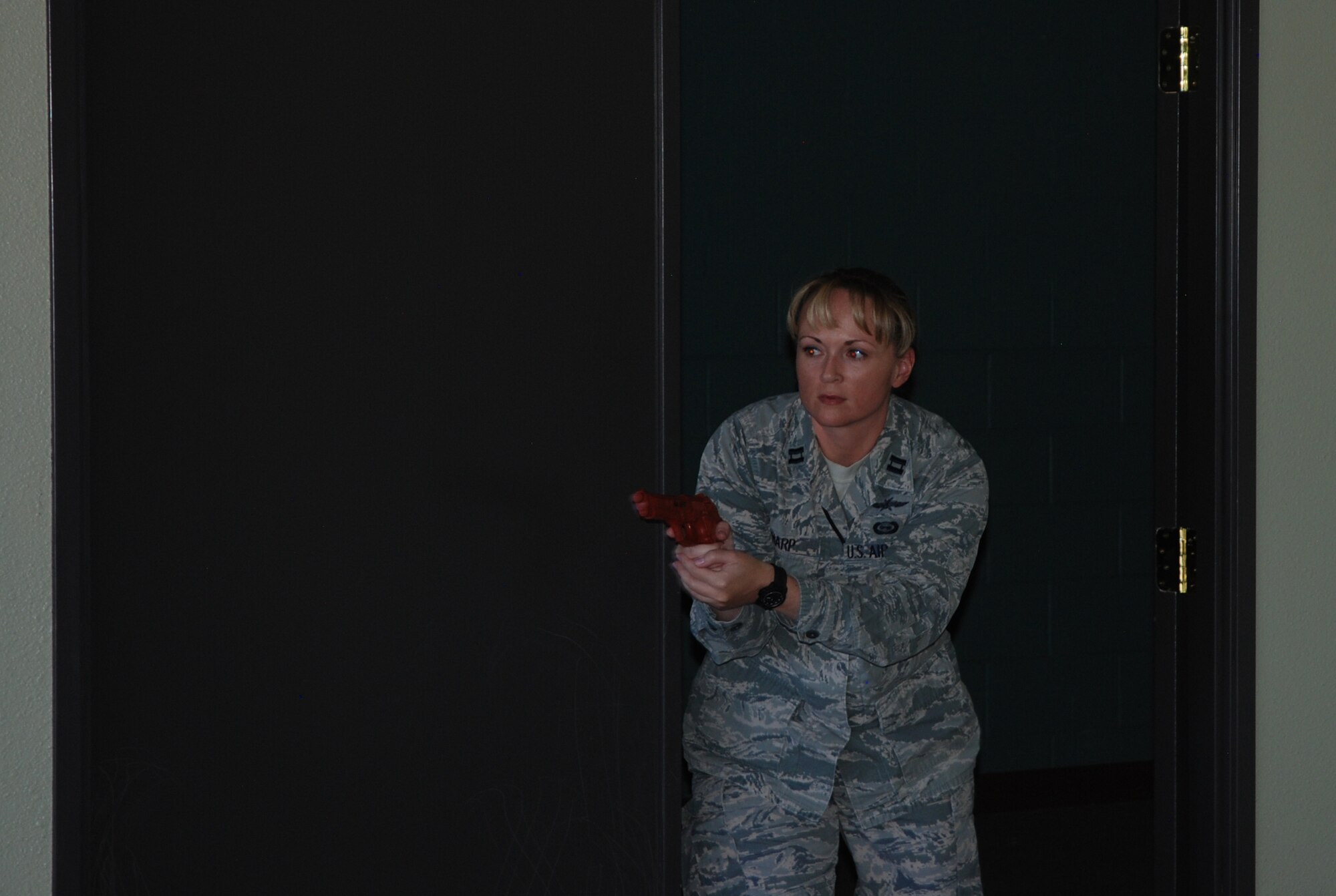 PETERSON AIR FORCE BASE, Colo. -- Capt. Michelle Sharp practices entering a room with a potential active shooter hiding inside. The Oct. 14, 2015 exercise was part of Expeditionary Active Shooter Training at Peterson AFB. The new classes, which began this month, are held weekly to accommodate deployment schedules. (U.S. Air Force photo by Dave Smith)