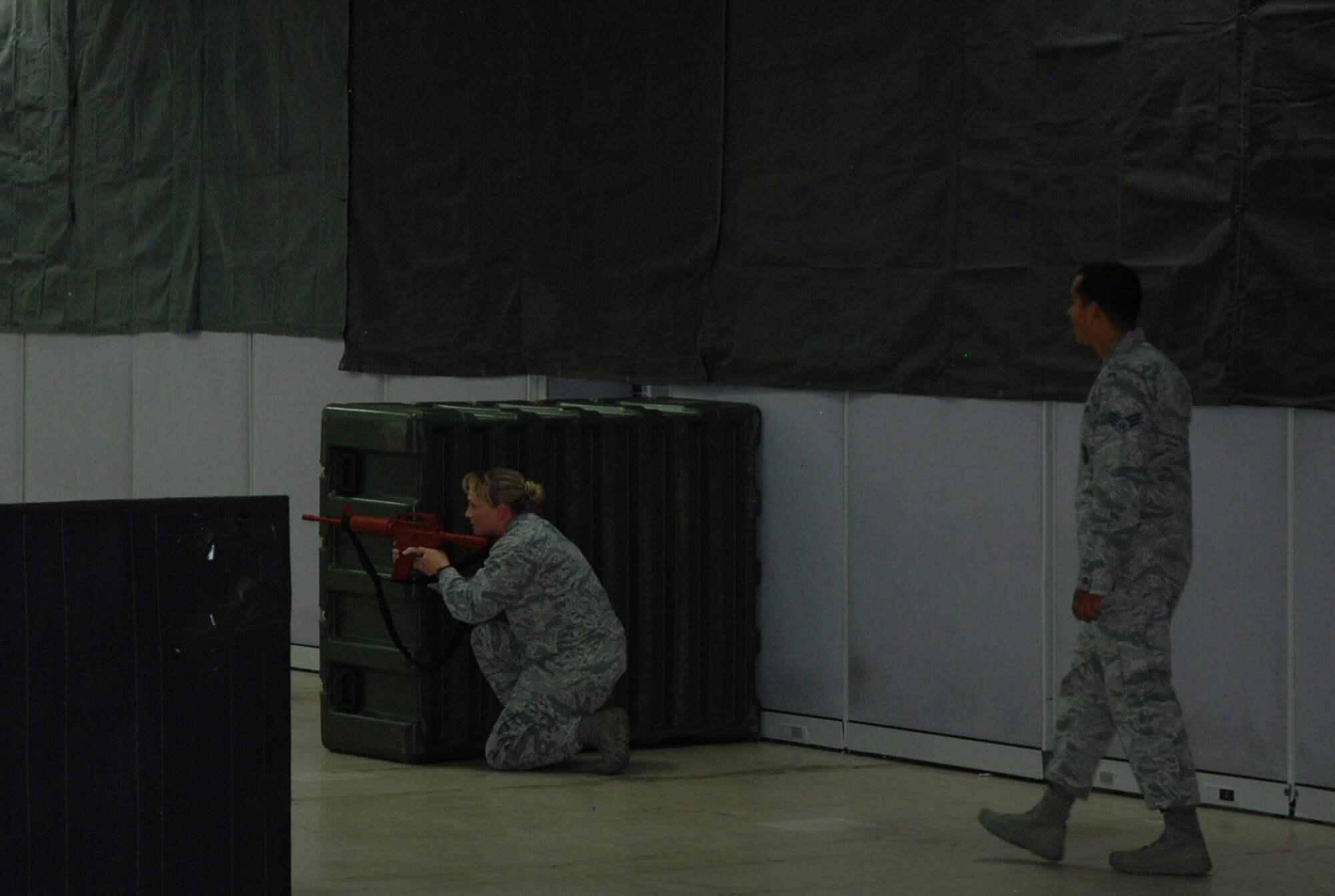 PETERSON AIR FORCE BASE, Colo. -- Senior Airman Christian Mejia, right, 721st Security Forces, oversees Capt. Michelle Sharp during Expeditionary Active Shooter Training Oct. 14, 2015 at Peterson AFB. The training is held weekly for all deploying Airmen, rotating between Peterson AFB, Schriever AFB and the U.S. Air Force Academy. (U.S. Air Force photo by Dave Smith)
