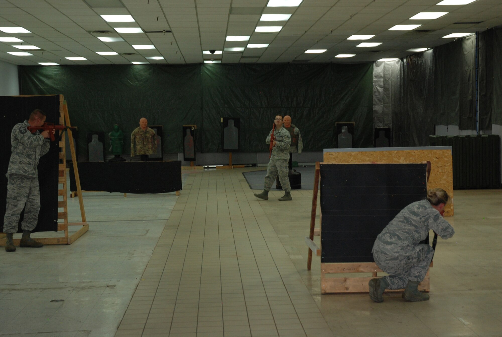 PETERSON AIR FORCE BASE, Colo. -- A team works on confronting an active shooter during Expeditionary Active Shooter Training, a new tier-two level training for all deploying Airmen, Oct. 14, 2015. Classes are held each week, rotating locations between Peterson AFB, Schriever AFB and the U.S. Air Force Academy. (U.S. Air Force photo by Dave Smith)