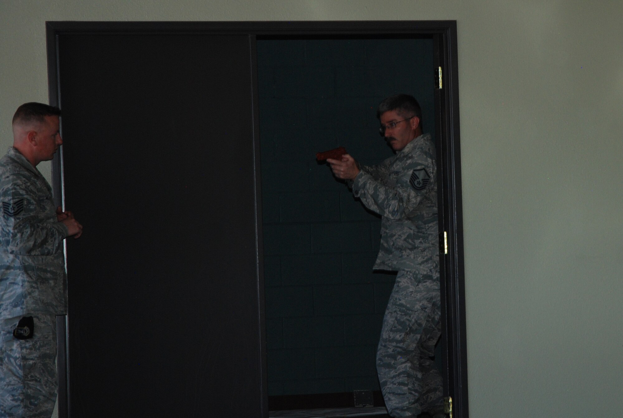 PETERSON AIR FORCE BASE, Colo. -- Tech. Sergeant Scott Willis, left, 21st Security Forces Squadron, monitors the technique of a student in the Expeditionary Active Shooter Training course Oct. 14, 2015. The course is a new tier-two level training for all deploying Airmen and is held weekly at rotating locations between Peterson AFB, Schriever AFB and the U.S. Air Force Academy. (U.S. Air Force photo by Dave Smith)