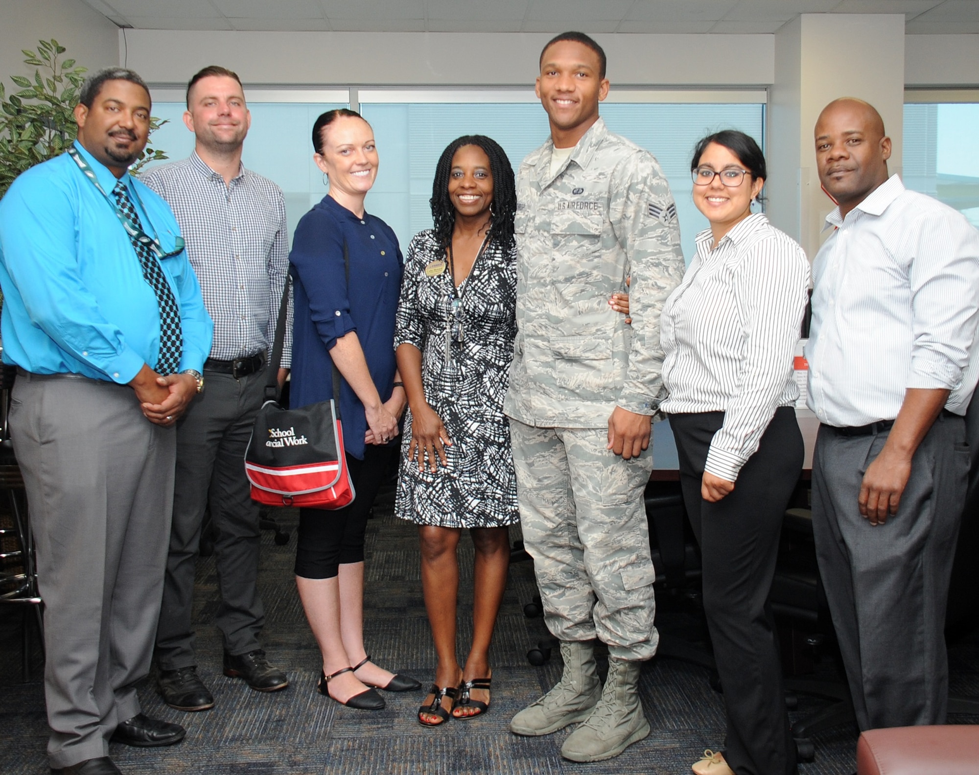 From left to right, Marc Person, 61st Force Support Squadron Airman and Family Readiness Center, student interns Jason Woodrum and Dejha Harris from the University of Southern California's Adults and Healthy Aging Department, Cathy Howard, 61st FSS director of the Airman and Family Readiness Center, Senior Airman Gerard Listhrop from the Space and Missile Systems Center's Financial Management Directorate, student interns Rebecca Dardon from USC's Community, Organization, Planning and Administration Department and John Howard from USC's Adults and Healthy Aging Department take a group photo during an introductory reception Sept. 9 hosted in the A&FRC at Los Angeles Air Force Base in El Segundo, Calif. A partnership between USC's Masters in Social Work program and the Space and Missile Systems Center at Los Angeles AFB will play a critical role in preparing future graduates for contemporary clinical issues in their chosen profession by providing.an understanding of military culture and the commitment that is made by the men and women of the armed forces, as well as the sacrifices of their families. (U.S. Air Force photo/Van De Ha).