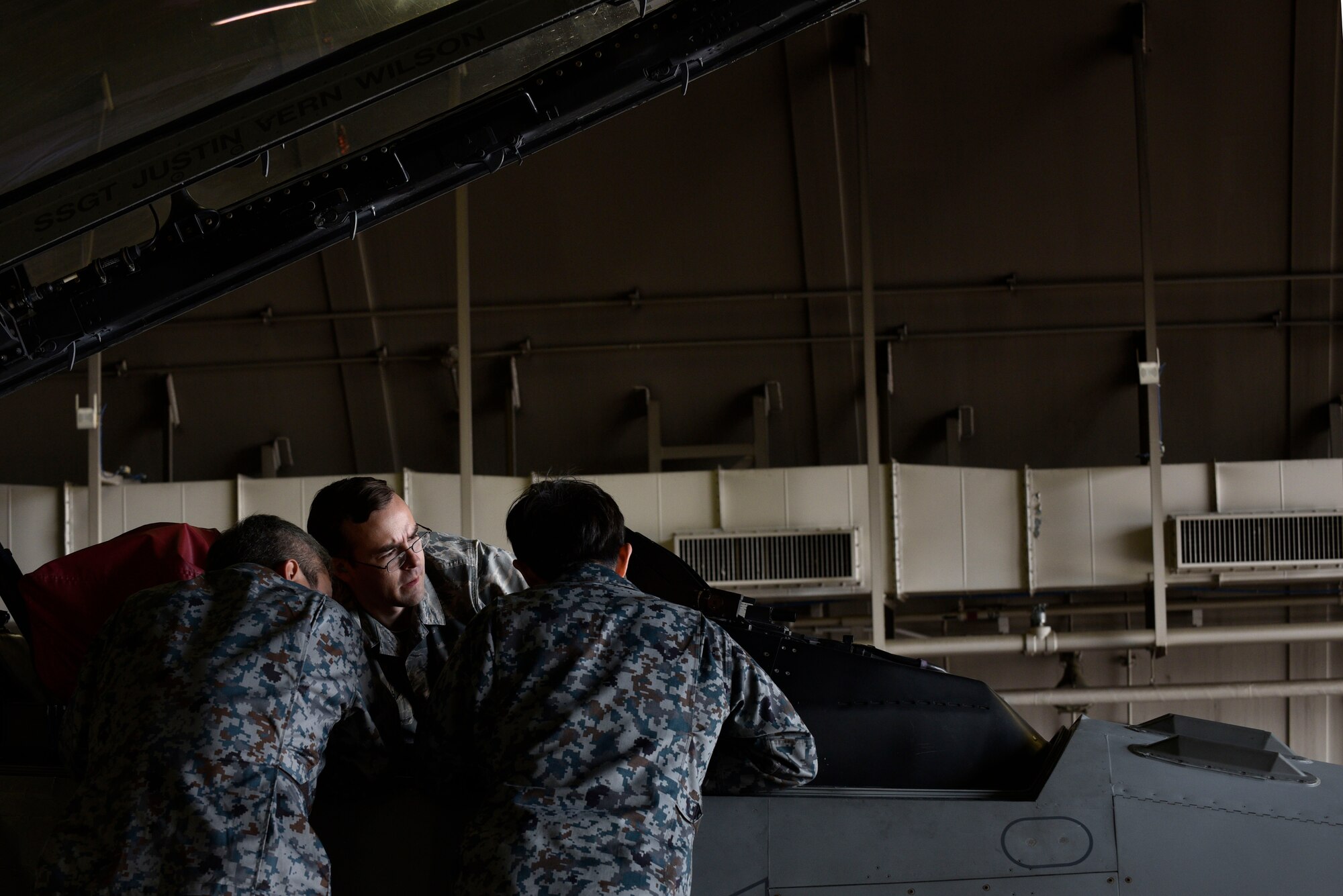 U.S. Air Force Staff Sgt. Matthew Harris, 35th Aircraft Maintenance Squadron avionics craftsman, explains cockpit troubleshooting procedures to Japan Air Self-Defense Force Tech. Sgt. Yuya Kanamori and Staff Sgt. Yuuichi Sato, at Misawa Air Base, Japan, Oct. 1, 2015. The program gave JASDF maintainers the opportunity to work in an all English environment, which helps prepare them for working with English technical data, schematics, operating instructions, and replacement parts of the F-35 Lightning II. The F-35 is scheduled to be deployed to Misawa during The Japanese government’s Fiscal Year 2017. (U.S. Air Force photo by Senior Airman Jose L. Hernandez-Domitilo/Released)