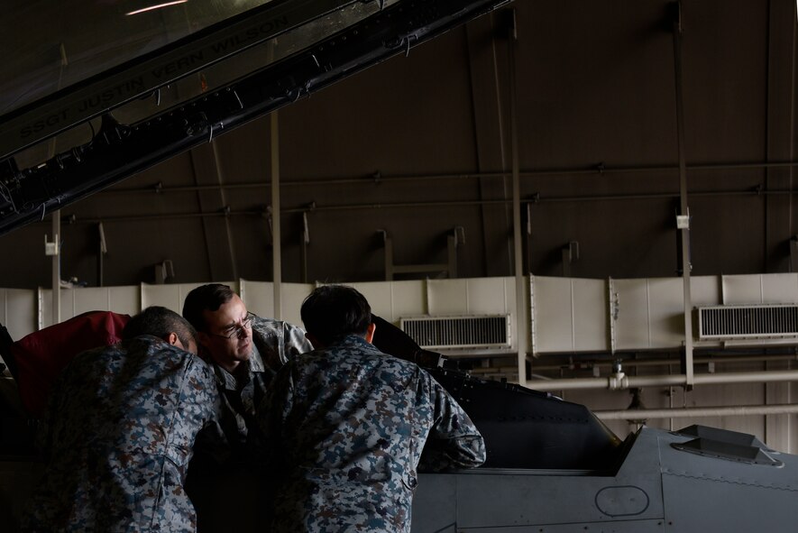 U.S. Air Force Staff Sgt. Matthew Harris, 35th Aircraft Maintenance Squadron avionics craftsman, explains cockpit troubleshooting procedures to Japan Air Self-Defense Force Tech. Sgt. Yuya Kanamori and Staff Sgt. Yuuichi Sato, at Misawa Air Base, Japan, Oct. 1, 2015. The program gave JASDF maintainers the opportunity to work in an all English environment, which helps prepare them for working with English technical data, schematics, operating instructions, and replacement parts of the F-35 Lightning II. The F-35 is scheduled to be deployed to Misawa during the Japanese government’s fiscal year 2017. (U.S. Air Force photo by Senior Airman Jose L. Hernandez-Domitilo/Released) 