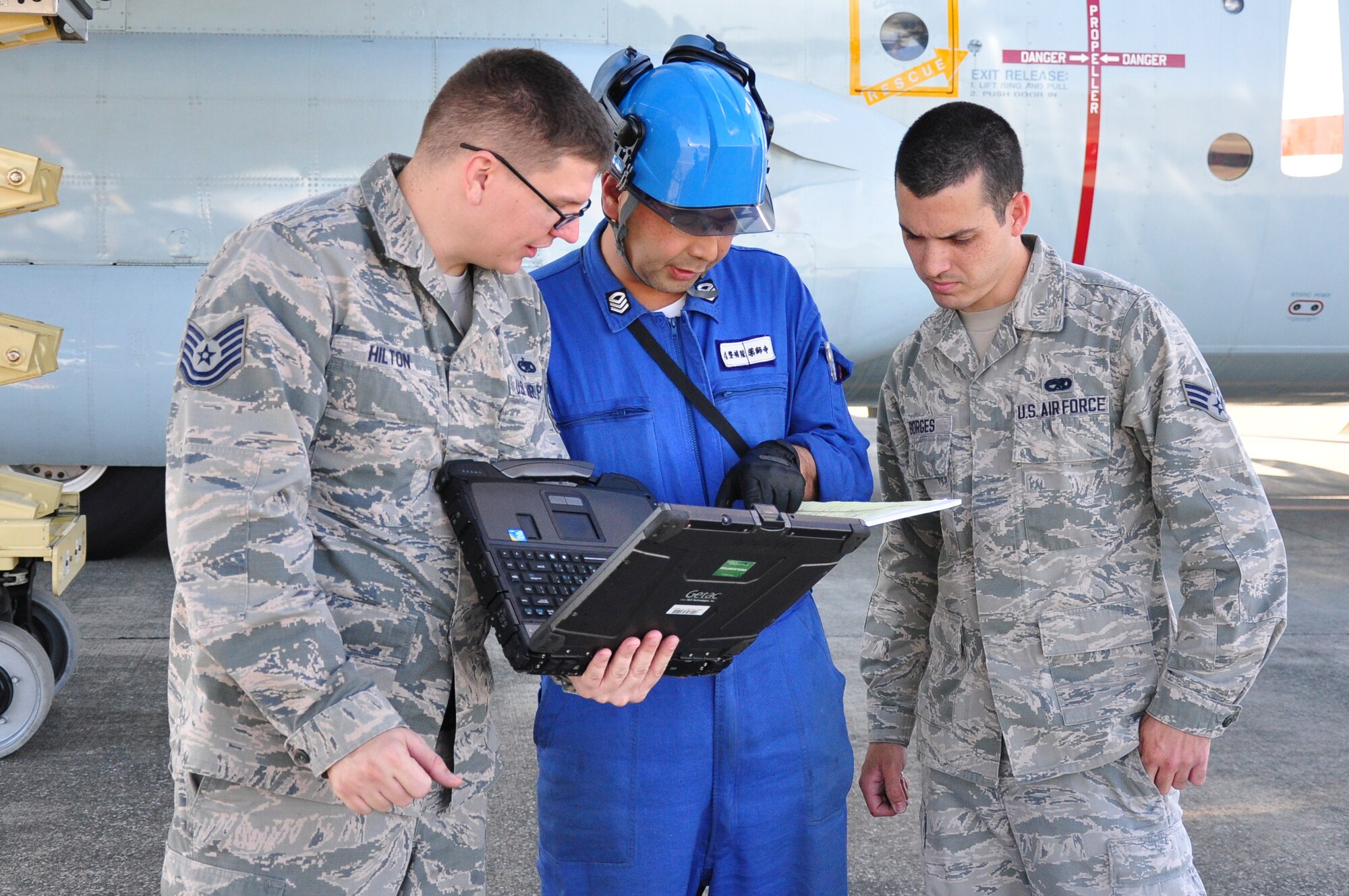 A Japan Maritime Self-Defense Force member works with Yokota technicians at Naval Air Facility Atsugi, Japan, Oct. 8, 2015. The Yokota technicians provided specialized maintenance test equipment and on-the-job training to the JMSDF maintenance personnel. (Courtesy photo by 374th Maintenance Group)