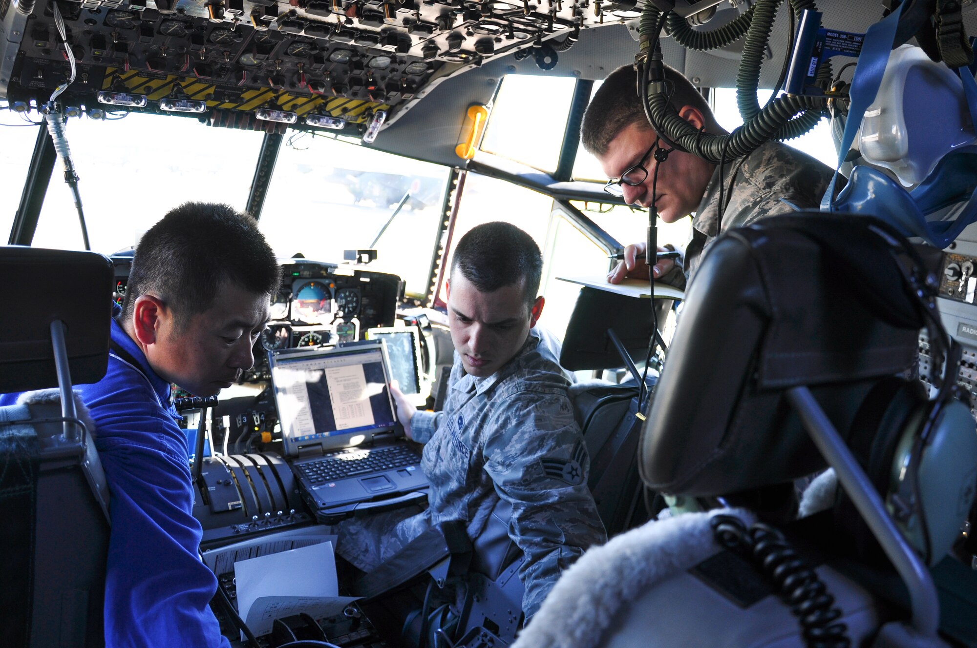 A Japan Maritime Self-Defense Force member works with Yokota technicians onboard a C-130R Hercules at Naval Air Facility Atsugi, Japan, Oct. 8, 2015. The Yokota technicians responded to the JMSDF request for support of four C-130R Hercules. (Courtesy photo by 374th Maintenance Group)