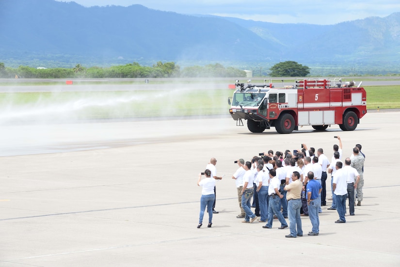 Members from the Honduran Defense College watch as the 612th Air Base Fire Department responds to a controlled fire during a visit to Soto Cano Air Base, Honduras, Oct. 16, 2015. The visit provided a better understanding of JTF-Bravo’s mission and capabilities for the Defense College members. (U.S. Air Force photo by Senior Airman Westin Warburton/Released)