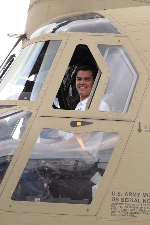 A member from the Honduran Defense College sits in the cockpit of a CH-47 Chinook helicopter during a visit to Soto Cano Air Base, Honduras, Oct. 16, 2015. The visit provided a better understanding of JTF-Bravo’s mission and capabilities for the Defense College members. (U.S. Air Force photo by Senior Airman Westin Warburton/Released)