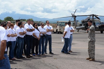 U.S. Army Sgt. Ruben Ramos, 1-228 aviation regiment, explains how the MH-60 Black Hawk helicopter works for the Honduran Defense College during a visit to Soto Cano Air Base, Honduras, Oct. 16, 2015. The visit provided a better understanding of JTF-Bravo’s mission and capabilities for the Defense College members. (U.S. Air Force photo by Senior Airman Westin Warburton/Released)