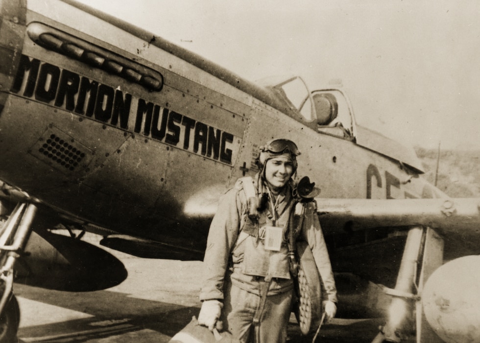 Roland R. Wright stands next to the P-51 Mormon Mustang he made his name flying in over Europe in WWII. Wright shot down three enemy aircraft during the war. 