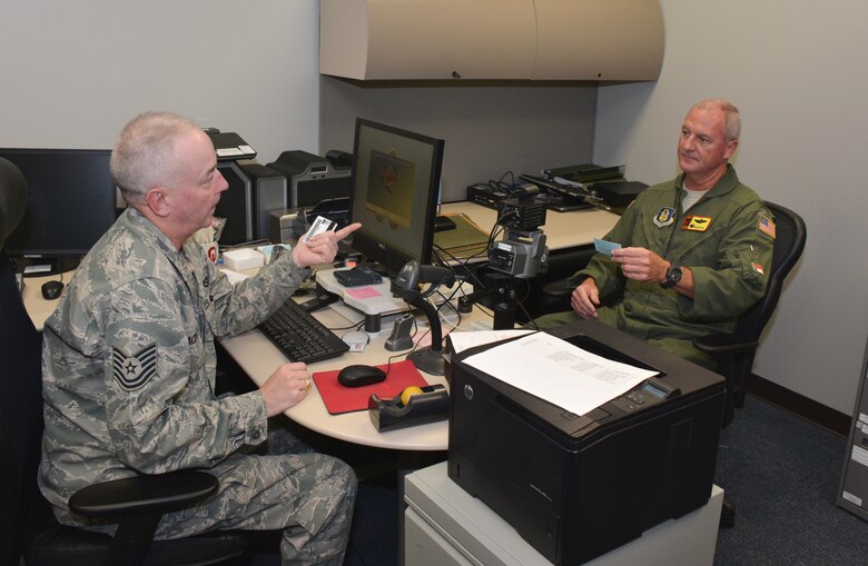 Tech. Sgt. James “Butch” Blackwell (left), 507th Force Support Squadron, issues the first common access card to 507th Air Refueling Wing commander, Col. Brian “B.S.” Davis at the new Military Personnel Section location in Building 1048, Room 112, Oct. 20, 2015 at Tinker Air Force Base, Okla. (U.S. Air Force photo/Maj. Jon Quinlan) 