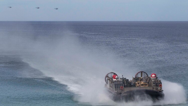 A landing craft air-cushion, or LCAC, transporting U.S. Marines, with the 26th Marine Expeditionary Unit and Portuguese Marines from the USS Arlington (LPD-24), Kearsarge Amphibious Ready Group (KSGARG) moves towards Pinheiro Da Cruz, Praia Da Raposa beach in Portugal, to participate in a combined amphibious assault exercise, Oct. 20, 2015, during Trident Juncture 15. Trident Juncture is a NATO-led exercise designed to certify NATO response forces and develop interoperability among participating NATO and partner nations. 