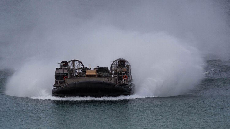 A landing craft air-cushion, or LCAC, transporting U.S. Marines, with the 26th Marine Expeditionary Unit and Portuguese Marines from the USS Arlington (LPD-24), Kearsarge Amphibious Ready Group (KSGARG) moves towards Pinheiro Da Cruz, Praia Da Raposa beach in Portugal, to participate in a combined amphibious assault exercise, Oct. 20, 2015, during Trident Juncture 15. Trident Juncture is a NATO-led exercise designed to certify NATO response forces and develop interoperability among participating NATO and partner nations. 