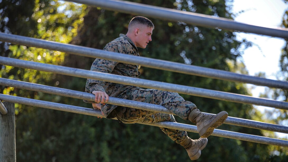 A Marine candidate with the Scout Sniper Screening Platoon, 2nd Battalion, 8th Marine Regiment, maneuvers over an obstacle as part of the Scout Sniper Physical Assessment Test at Camp Lejeune, N.C., Oct. 19, 2015. The obstacle course served as the final evolution for the assessment, requiring two consecutive completions from each candidate. 