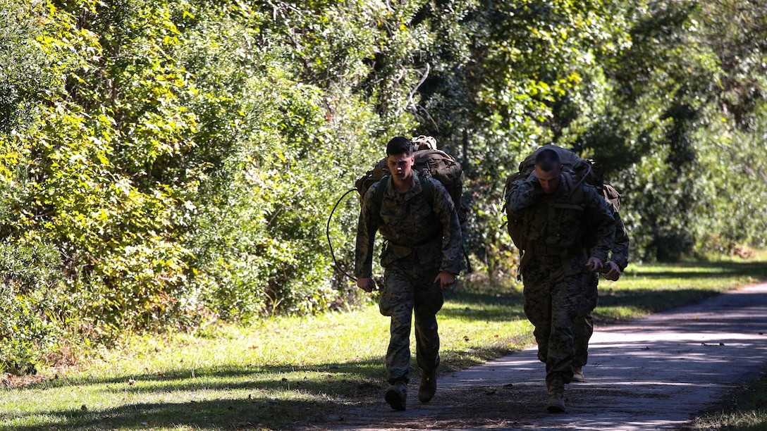 Marine candidates with the Scout Sniper Screening Platoon, 2nd Battalion, 8th Marine Regiment, conduct a 12-mile ruck run as part of the Scout Sniper Physical Assessment Test at Camp Lejeune, N.C., Oct. 19, 2015. The run required 50 pounds of equipment and had a time limit of three hours.
