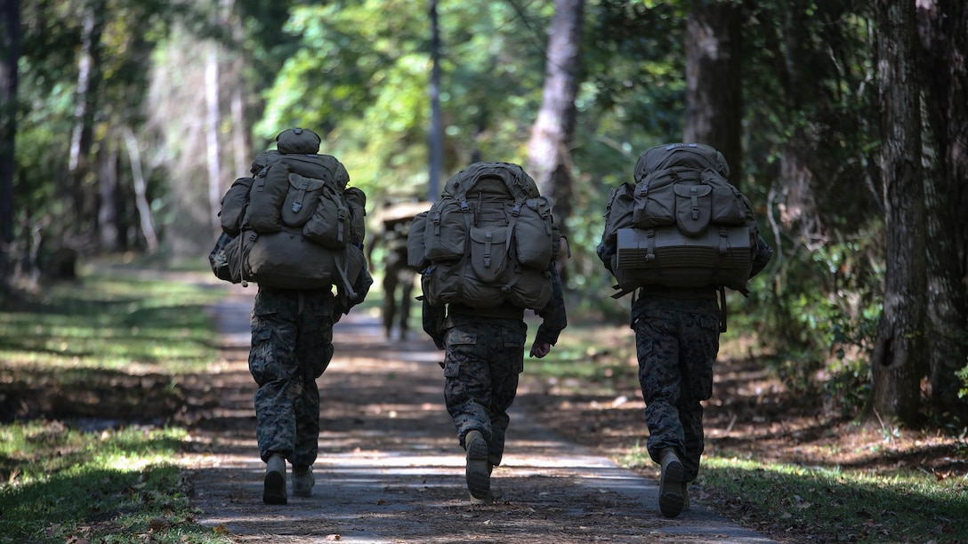 Marine candidates with the Scout Sniper Screening Platoon, 2nd Battalion, 8th Marine Regiment, conduct a 12-mile ruck run as part of the Scout Sniper Physical Assessment Test at Camp Lejeune, N.C., Oct. 19, 2015. The run required 50 pounds of equipment and a time limit of three hours. 