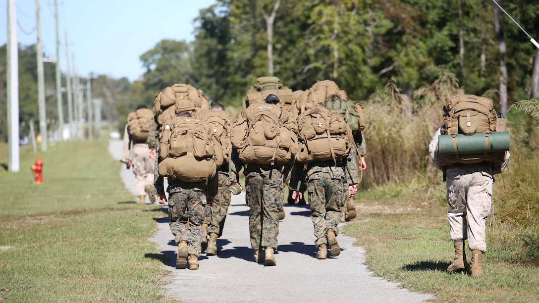 Marine candidates with the Scout Sniper Screening Platoon, 2nd Battalion, 8th Marine Regiment, begin a 12-mile ruck run as part of the Scout Sniper Physical Assessment Test at Camp Lejeune, N.C., Oct. 19, 2015. The run required 50 pounds of equipment and a time limit of three hours. 