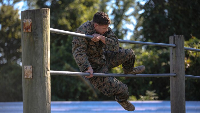 A Marine candidate with the Scout Sniper Screening Platoon, 2nd Battalion, 8th Marine Regiment, maneuvers over an obstacle as part of the Scout Sniper Physical Assessment Test at Camp Lejeune, N.C., Oct. 19, 2015. The obstacle course served as the final evolution for the assessment, requiring two consecutive completions from each candidate. 