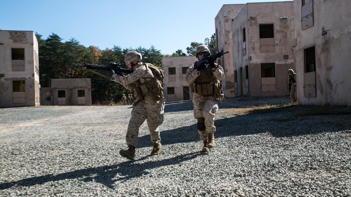 Marines from Alpha Company, Marine Barracks Washington, D.C. search a vehicle at a vehicle control point as part of a military operations in urban terrain exercise at Marine Corps Base Quantico, Virginia, Oct. 15, 2015.