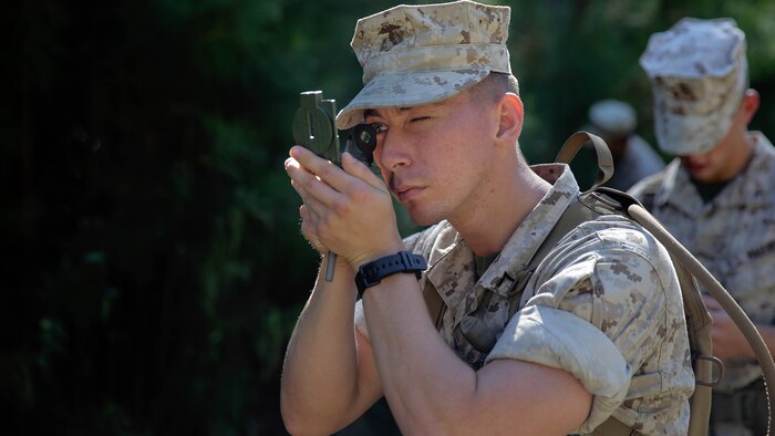Pfc. Douglas Masters, a mortar man with 2nd Battalion, 8th Marine Regiment, calibrates his compass by reading a predetermined azimuth before a land navigation course in preparation for the scout sniper platoon screener, Oct. 14, 2015, at Marine Corps Base Camp Lejeune, N.C.  More than 15 Marines with the battalion are taking part in the course to prepare themselves for the scout sniper platoon screener. 