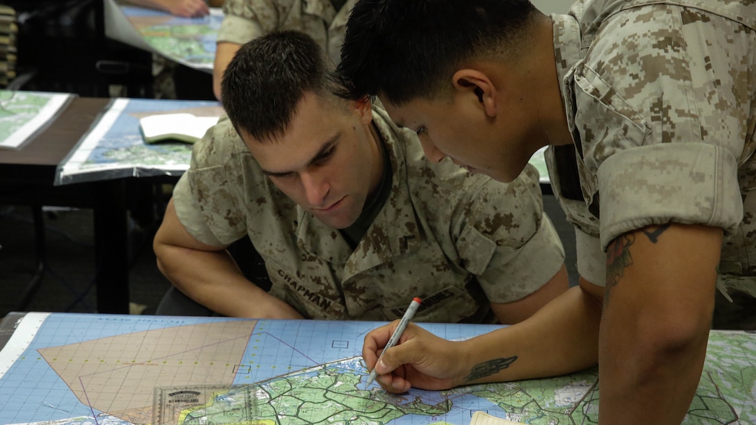 A Marine with 2nd Battalion, 8th Marine Regiment, is showing techniques with land navigation during a class in preparation for the scout sniper platoon screener, Oct. 14, 2015, at Marine Corps Base Camp Lejeune, N.C.  Marines from 3rd Battalion, 6th Marine Regiment, and 3rd Battalion, 8th Marine Regiment, are helping to teach and mentor new Marines for the platoon.  
