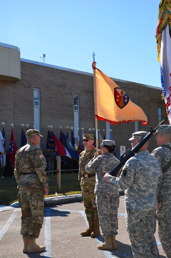 Command Sgt. Maj. Vicki Briggs, command sergeant major of the Army Reserve Sustainment Command of Birmingham, Ala., prepares to pass the unit colors to Maj. Gen. Les Carroll, commanding general of the 377th Theater Sustainment Command, Belle Chasse, La., before he passes the colors to Brig. Gen. Jeffrey Doll charging him with the responsibility and authority of the ARSC.