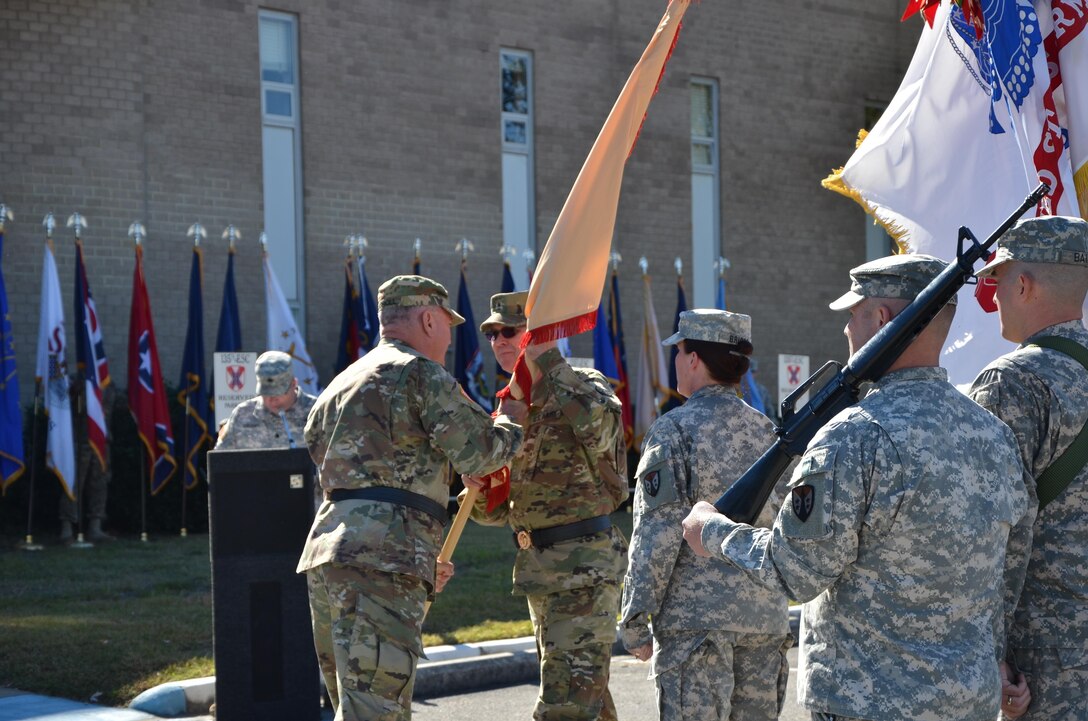 Maj. Gen. Les Carroll, commanding general of the 377th Theater Sustainment Command, Belle Chasse, La., passes the Army Reserve Sustainment Command’s colors to Brig. Gen. Jeffrey Doll charging him with the responsibility and authority of the ARSC during the ARSC’s Assumption of Command Ceremony on Oct. 17.