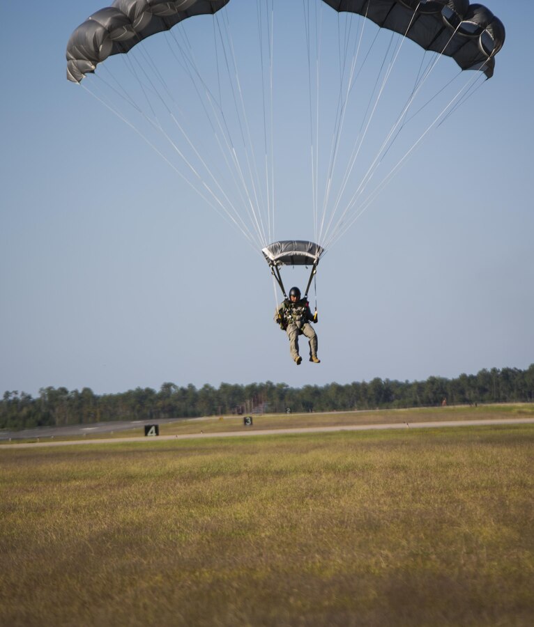 Marines with 3rd Force Reconnaissance Company, 4th  Marine Division, Marine Forces Reserve,  touch down at their designated drop zone following a high altitude – high opening jump during parachute insertion training at Stennis International Airport, Miss., Oct. 15, 2015. The goal of the training was to sharpen a skill set that is of great advantage to expeditionary forces, allowing the jumpers to infiltrate locations where access would be too difficult for vehicles. 