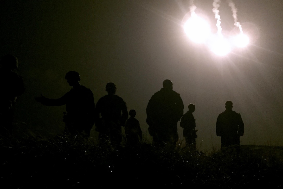 Flares from a C-130 Hercules transportation aircraft illuminate the evening sky over U.S. Marines during a fire support coordination exercise to kick off Blue Chromite on a landing zone on Okinawa, Japan, Oct. 21, 2015. Blue Chromite is a large-scale air-ground training exercise designed to build upon the Marine Corps’ sea-borne, rapid-reaction capabilities while maintaining the Corps’ strategic presence in the Pacific. U.S. Marine Corps photo