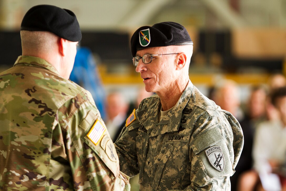 Army Reserve Brig. Gen. William Barriage (right), the commanding general of the 351st Civil Affairs Command, passes the sword to Command Sgt. Maj. Gregory Thomsen during the Change of Responsibility Ceremony held at Moffett Field, Calif., Oct. 17. Thomsen took the helm as the senior enlisted Soldier from Command Sgt. Maj. Mark Martello. The 351st CACOM has more than 2,100 Soldiers in eight states, to include Hawaii. The 351st CACOM is assigned to the U.S. Army Civil Affairs and Psychological Operations Command (Airborne) based at Fort Bragg, N.C. USACAPOC (A) has more than 13,000 Soldiers with Civil Affairs, Psychological Operations and Information Operations units across the country. USACAPOC(A) has 94 percent of the Army’s General Purpose Forces’ CA Capability, 100 percent of the Army’s General Purpose Forces’ PSYOP Capability and 42 percent of the Army’s General Purpose Forces’ I/O Capability. The command also has oversight of all Army Reserve airborne operations.