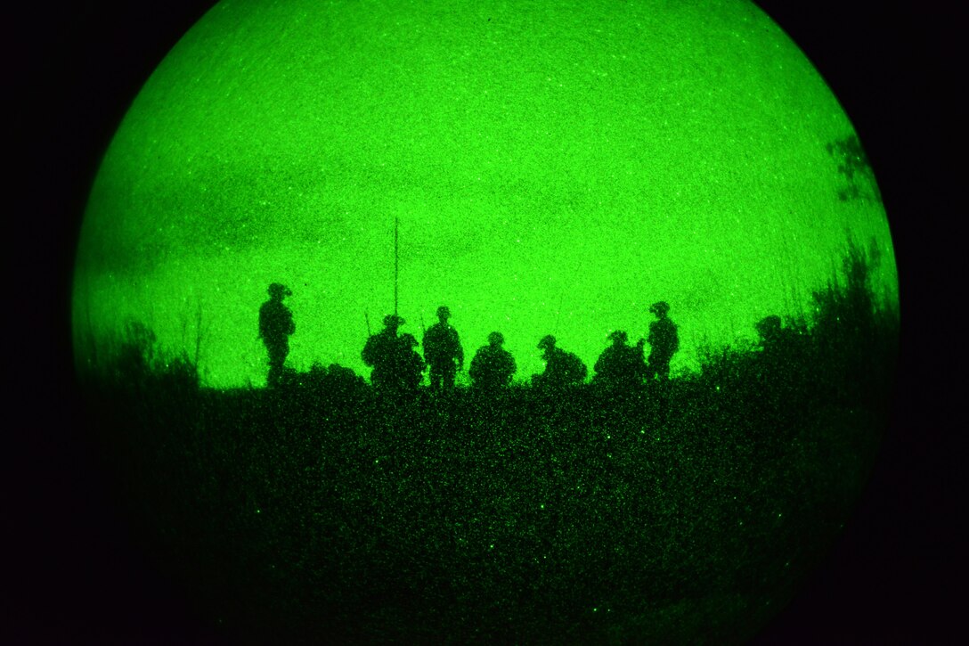 As seen through a night-vision device, U.S. paratroopers prepare for a night live-fire exercise as part of Exercise Rock Proof V at Pocek Range in Postonja, Slovenia, Oct. 18, 2015. The paratroopers are assigned to the 2nd Battalion, 503rd Infantry Regiment, 173rd Airborne Brigade. Rock Proof V is a bilateral training exercise focused on small-unit tactics and building interoperability between U.S. soldiers and the Slovenian armed forces. U.S. Army photo by Davide Dalla Massara