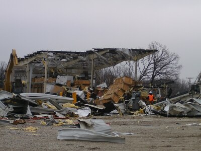 Extensive damage documented by the 88th Regional Support Command of Equipment Concentration Site – 66 at Fort Leonard Wood, Mo., after being struck by a tornado on Dec. 31, 2010. Continuity of Operation Plans allow the 88th RSC to maintain mission essential functions in this type of emergency. In order to be prepared for future emergencies, the 88th RSC’s Crisis Action Team members conducted a Continuity of Operations Plan Exercise on Fort McCoy, Wis., Oct.14. Charles Hudson, 88th Regional Support Command chief of staff said he knows firsthand how important it is to have a COOP in place in the event of a natural disaster.

“The COOP’s priority of effort is to ensure mission essential functions are met,” Hudson said, “and then to ensure minimum degradation of customer support to commands within the 88th RSC geographic area of responsibility.”


“The ability to implement the COOP was instrumental to recovery operations at Equipment Concentration Site – 66 at Fort Leonard Wood when it was struck by a tornado on December 31st, 2010,” Hudson explained.

“Fortunately this was a Federal Holiday or we would have experienced loss of life.  As it was, we lost $2.7M in equipment destroyed, $3.4M in equipment damage, and $5.5M in facilities repair and replacement,” Hudson continued.

“We accounted for 100% of ECS personnel that day, none were impacted personally, and most were called in to work over the weekend to secure equipment and facilities, account for property and begin the slow recovery process,” Hudson said.

“It took nearly a year for ECS-66 to recover from this event and much of that time was spent operating in temporary facilities elsewhere on Fort Leonard Wood. In addition, warehouse operations had to move 140 miles to an available warehouse at Weldon Springs Local Training Area in Saint Charles, Mo., Hudson said.

“Given this real-world scenario,” Hudson said, “a COOP for the 88th RSC Headquarters is very important.”