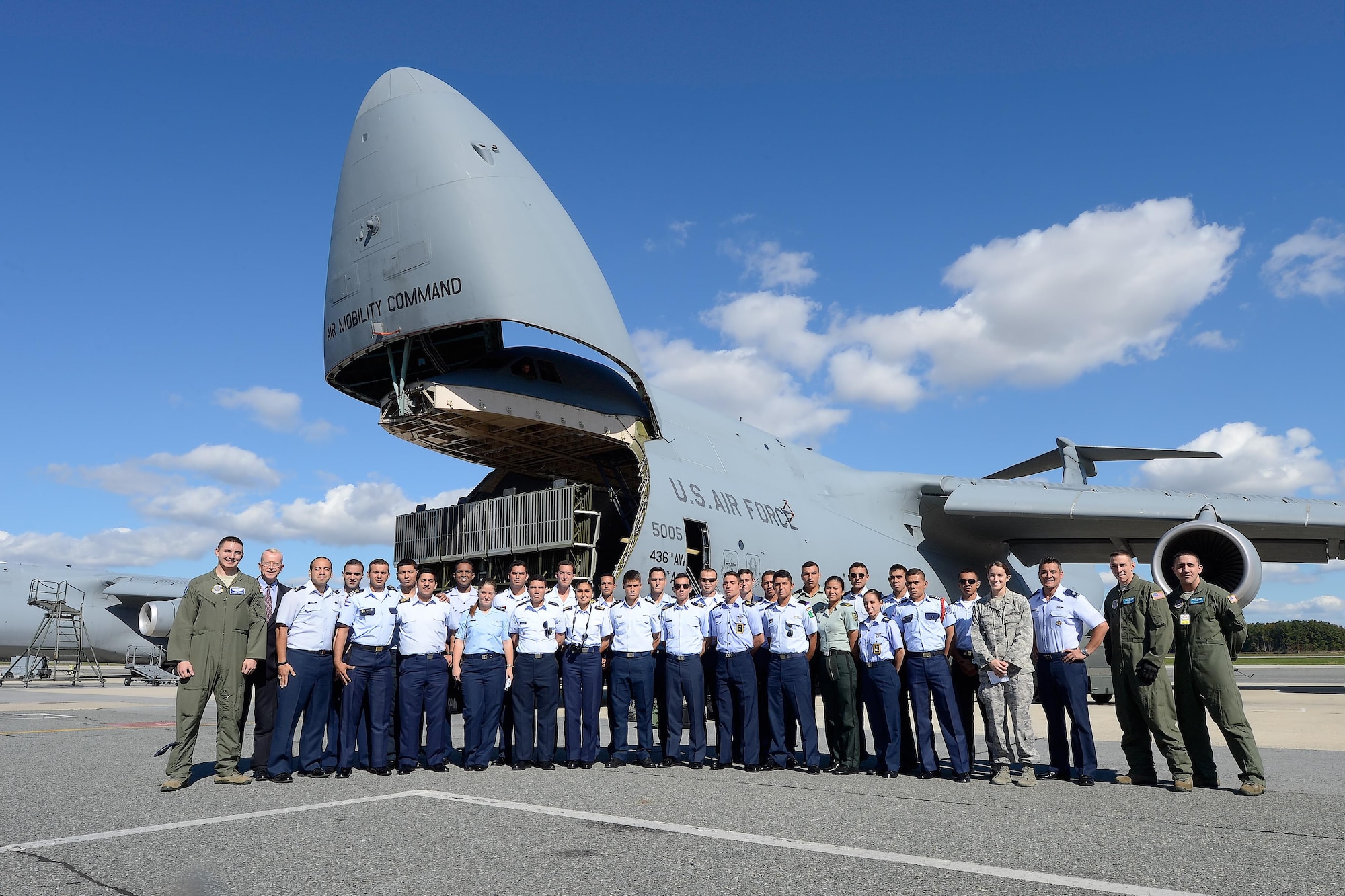 Latin American cadets, hosts from the Office of the Secretary of the Air Force's International Affairs Office and personnel from the 436th Airlift Wing, stand in front of a C-5M Super Galaxy Oct. 15, 2015, at Dover Air Force Base, Del. The nose of the aircraft is in the raised position as part of the demonstration given to the cadets showing how heavy equipment can roll-on/roll-off of the cargo transport aircraft. (U.S. Air Force photo/Greg L. Davis)