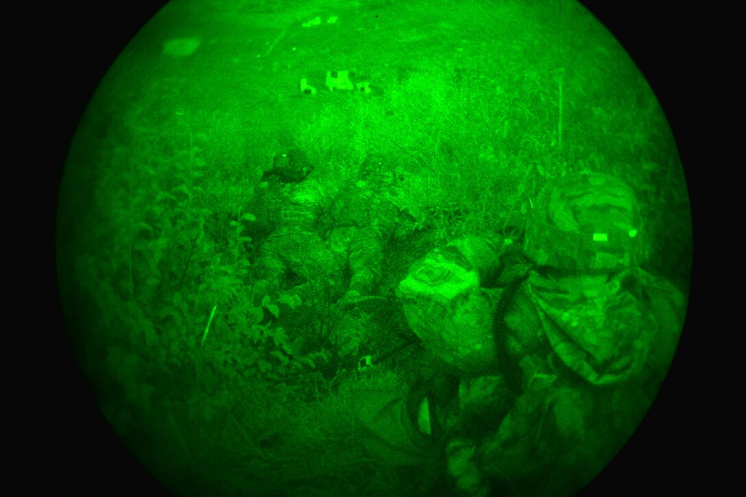 As seen through a night-vision device, U.S. paratroopers prepare for a night live-fire exercise as part of Exercise Rock Proof V at Pocek Range in Postonja, Slovenia, Oct. 19, 2015. U.S. Army photo by Davide Dalla Massara