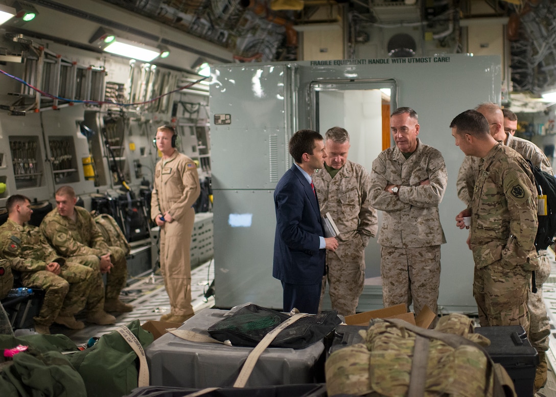 U.S. Marine Corps Gen. Joseph F. Dunford Jr., chairman of the Joint Chiefs of Staff, talks with members of his staff aboard a C-17 flying out of Baghdad, Iraq, Oct. 20, 2015. DoD photo by D. Myles Cullen