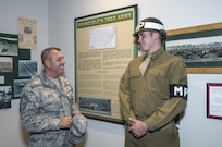 Chief Master Sgt. Scott Berge (left), 33rd Fighter Wing command chief master sergeant, speaks with Airman 1st Class Lucas Hurt, 502nd Security Forces Squadron entry controller, Oct. 14 at the Fort Sam Houston Museum.