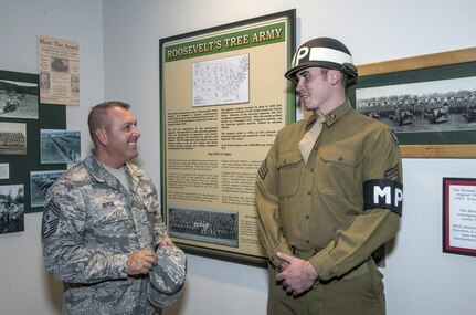 Chief Master Sgt. Scott Berge (left), 33rd Fighter Wing command chief master sergeant, speaks with Airman 1st Class Lucas Hurt, 502nd Security Forces Squadron entry controller, Oct. 14 at the Fort Sam Houston Museum.