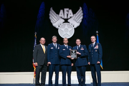 Capt. John McCann and Maj. Brent Cox, 560th Flying Training Squadron flight commanders, hold the Air Force Association’s Citation of Honor that was presented to the squadron last month at the AFA’s 2015 Air and Space Conference and Technology Exposition in National Harbor, Md. The flight commanders are flanked by Scott Van Cleef (left), AFA chairman of the board; Lt. Col. Joel DeBoer, 560th FTS commander; and Lt. Gen. Darryl Roberson, Air Education and Training Command commander.