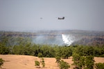 A Texas Army National Guard CH-47 Chinook from Grand Prairie and a UH-60 Black Hawk from the Austin Army Aviation Facility assist in suppressing a wildfire in Bastrop County, Texas. 