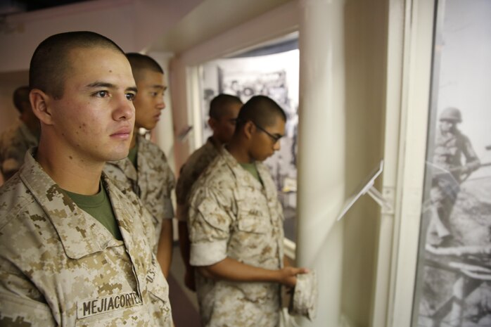 Recruits of Bravo Company, 1st Recruit Training Battalion, watch a slide show of old Marine Corps photos during their museum visit at Marine Corps Recruit Depot San Diego, Oct. 7. The museum owns more than 2,000 artifacts that date from the early days of the Marine Corps to items used today. Today, all males recruited from west of the Mississippi are trained at MCRD San Diego. The depot is responsible for training more than 16,000 recruits annually. Bravo Company is scheduled to graduate from recruit training on Oct. 23.