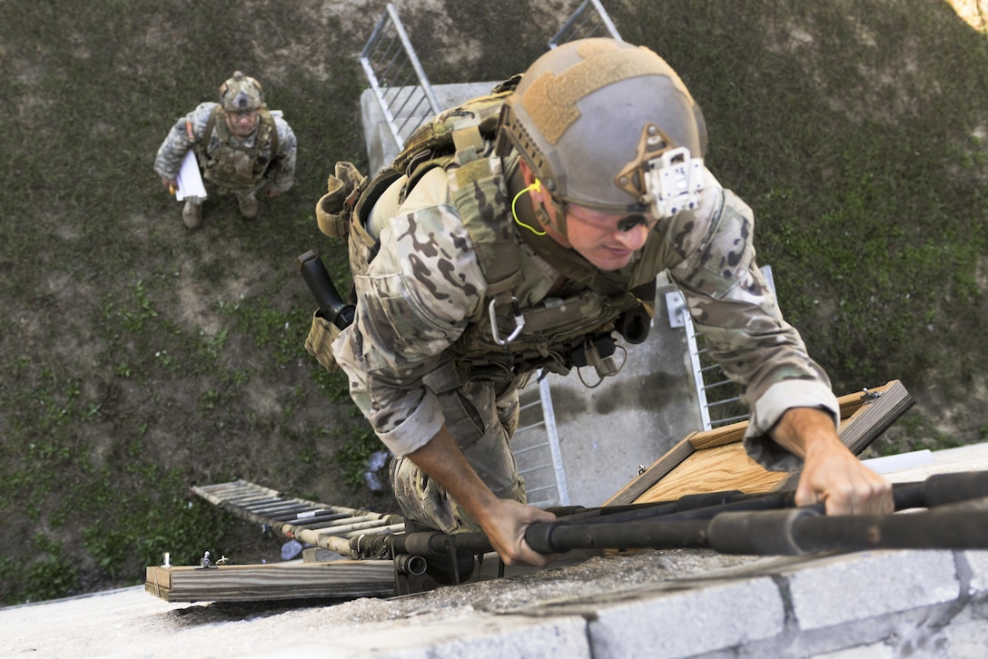 A Green Beret soldier climbs to the roof during a stress shoot competition on Eglin Air Force Base, Fla., Oct. 15, 2015. He is assigned to the 7th Special Forces Group. The competition tests the Special Forces soldier's ability to navigate terrain and obstacles while engaging targets accurately despite an elevated heart rate and rapid breathing. U.S. Army photo by Staff Sgt. William Waller