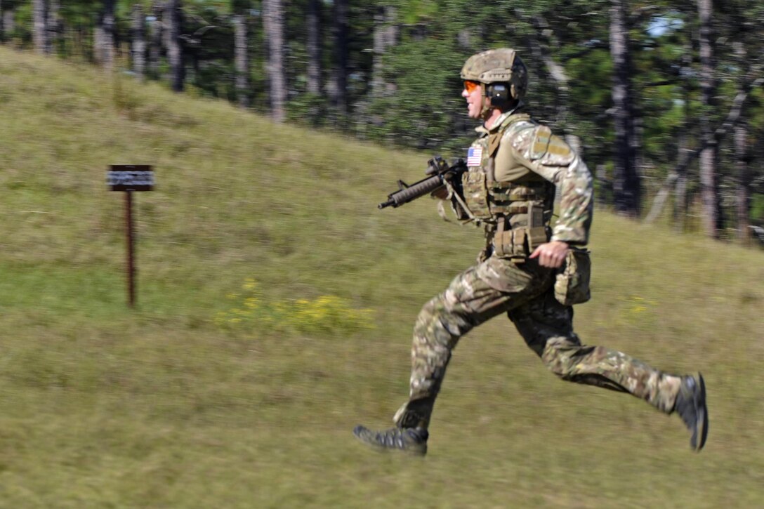 A Green Beret soldier sprints from the starting line to his first firing position during a stress shoot competition on Eglin Air Force Base, Fla., Oct. 15, 2015. He is assigned to the 7th Special Forces Group. The competition tests the Special Forces soldier's ability to navigate terrain and obstacles while engaging targets accurately despite an elevated heart rate and rapid breathing. U.S. Army photo by Staff Sgt. William Waller