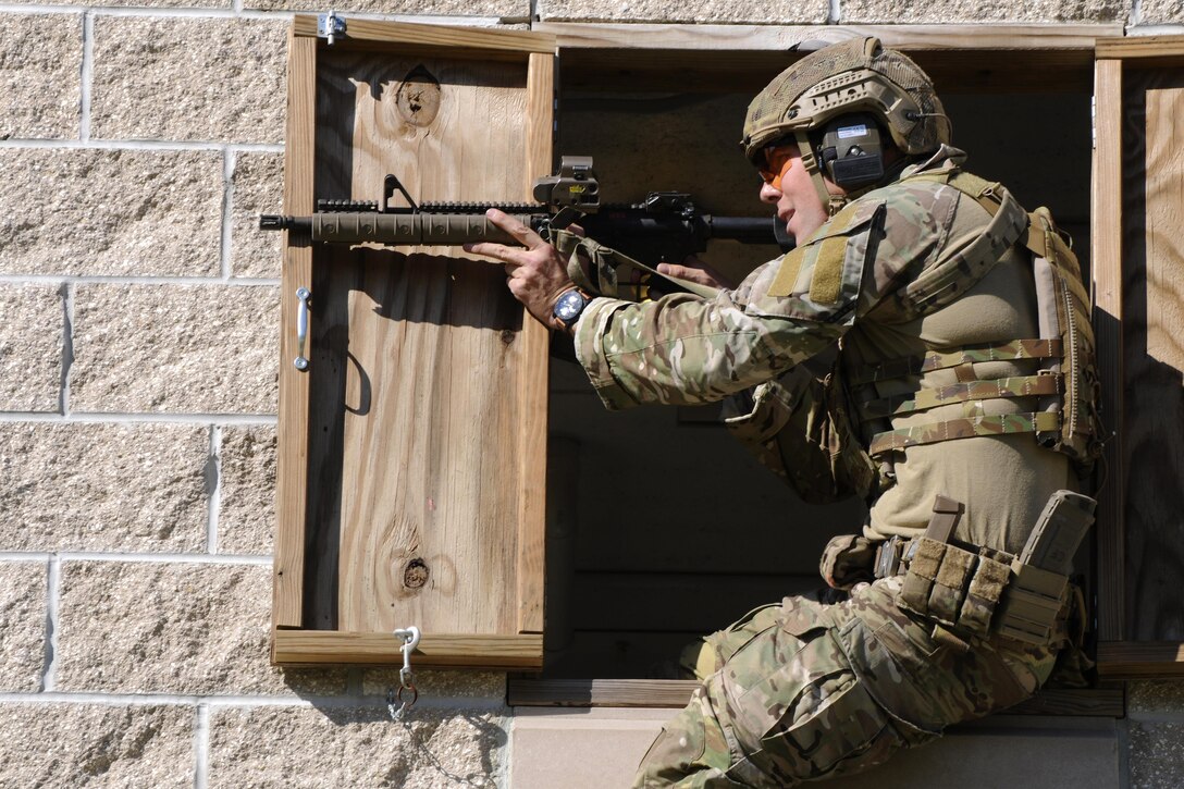 A Green Beret soldier fires a rifle during a stress shoot competition on Eglin Air Force Base, Fla., Oct. 15, 2015. He is assigned to the 7th Special Forces Group. The competition tests the Special Forces soldier's ability to navigate terrain and obstacles while engaging targets accurately despite an elevated heart rate and rapid breathing. U.S. Army photo by Staff Sgt. William Waller
