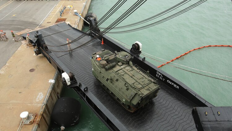 An Assault Amphibious Vehicle rolls off the USNS Sergeant William R. Button, a prepositioning ship that transported more than 130 pieces of vehicles and cargo to Rota, Spain, for Marines to support Exercise Trident Juncture 15, Oct. 21. The exercise is NATO’s largest since 2002 and will include more than 30 nations participating.