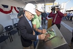 PASCAGOULA, Miss. - The keel of the future USS Paul Ignatius (DDG 117) is authenticated by the ship’s namesake, the Honorable Paul Ignatius (left) and Mr. Bill Jones, the Hull Superintendent (right) during a ceremony Oct. 20. Both authenticators etched their initials into the keel plate to symbolically recognize the joining of modular components and the ceremonial beginning of the ship. Paul Ignatius, a Flight IIA ship, is the first ship in the FY2013-FY2017 multi-year procurement contract to start fabrication and is scheduled to deliver in 2018. The ship will serve as an integral player in global maritime security, engaging in air, undersea, surface, strike and ballistic missile defense. (US Navy Photo released) 